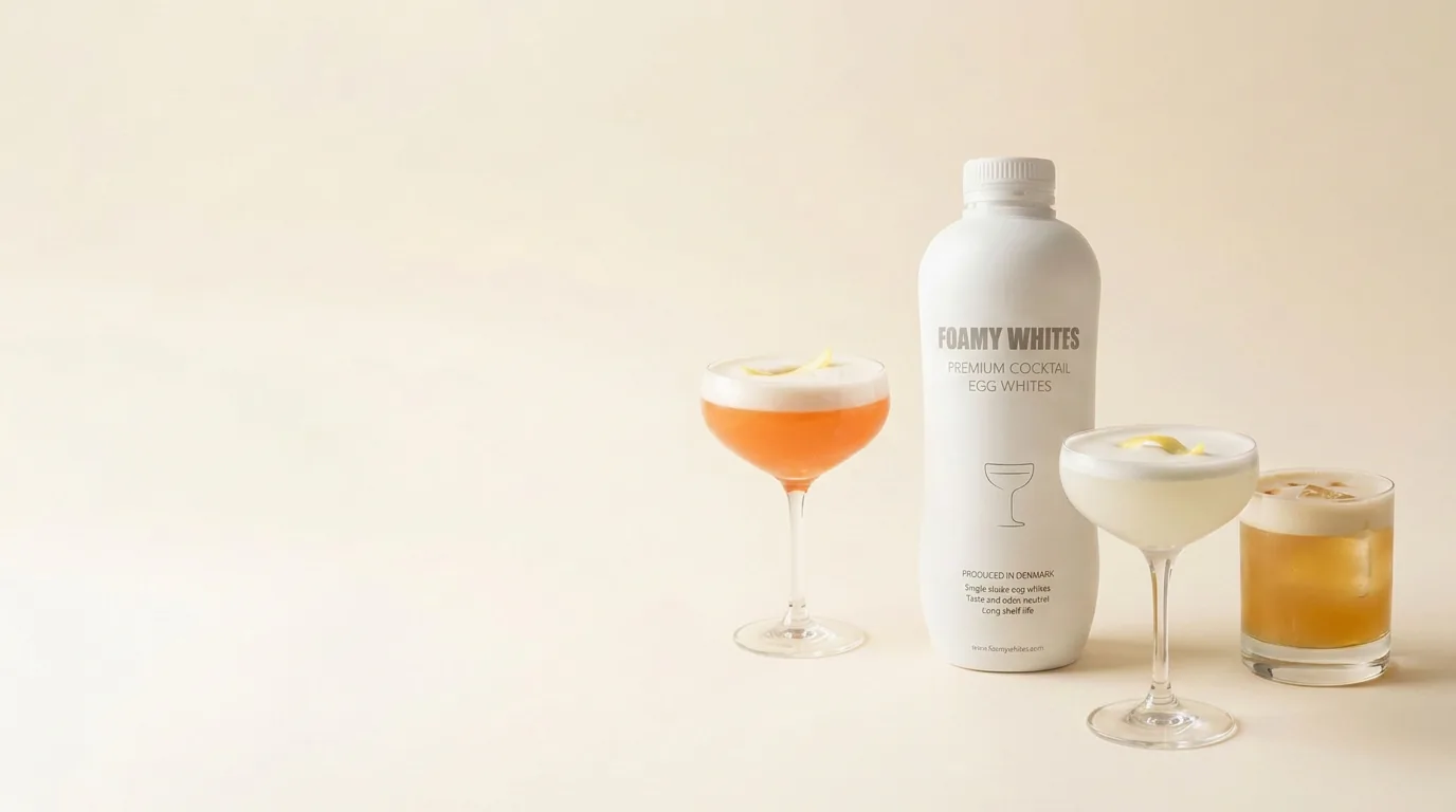 The FOAMY WHITES bottle beside three finished sours on warm ivory