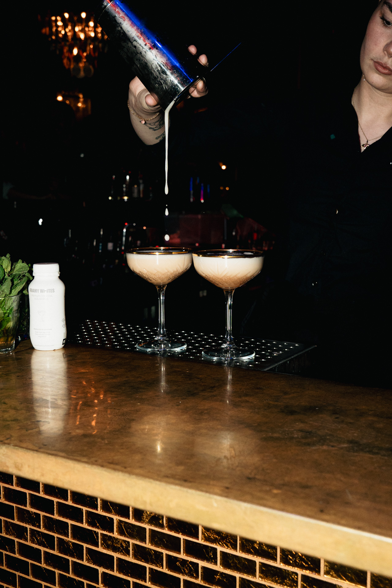 A precise pour into paired coupes.