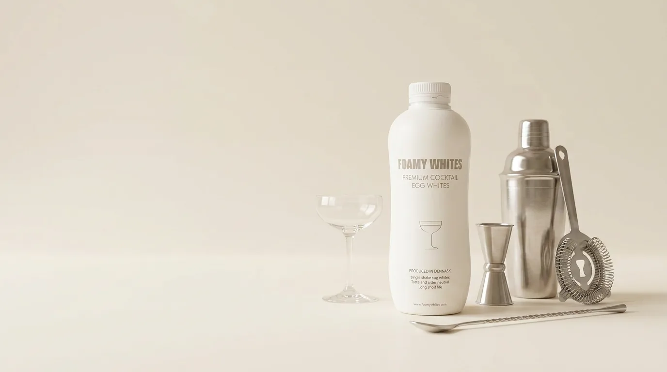 A FOAMY WHITES bottle and bar tools arranged on the counter before service