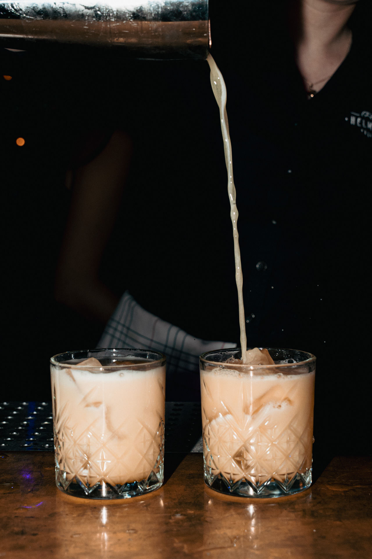 A long pour into two rocks glasses.