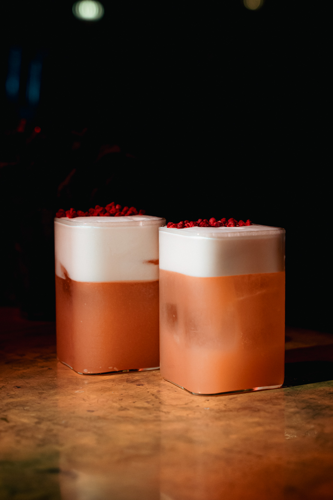 A cocktail against the wood of the bar.